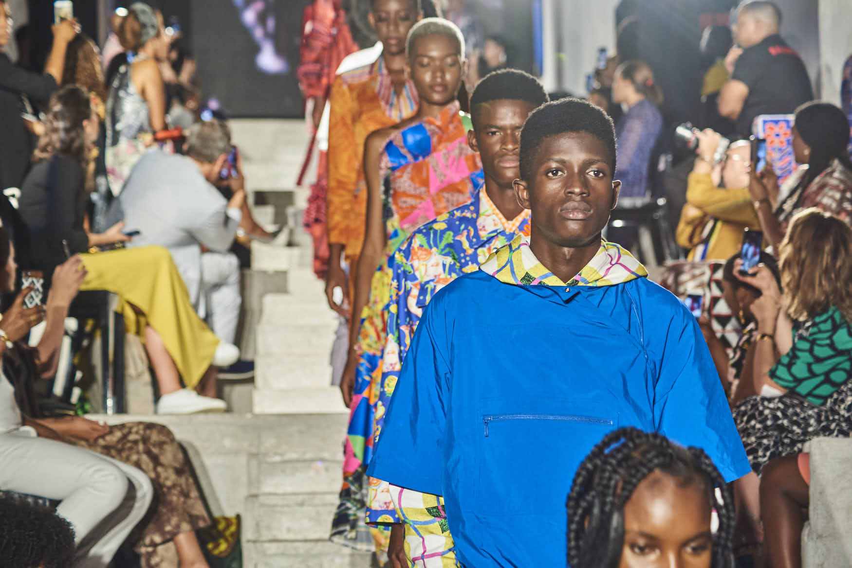 Runway models lined up on stage