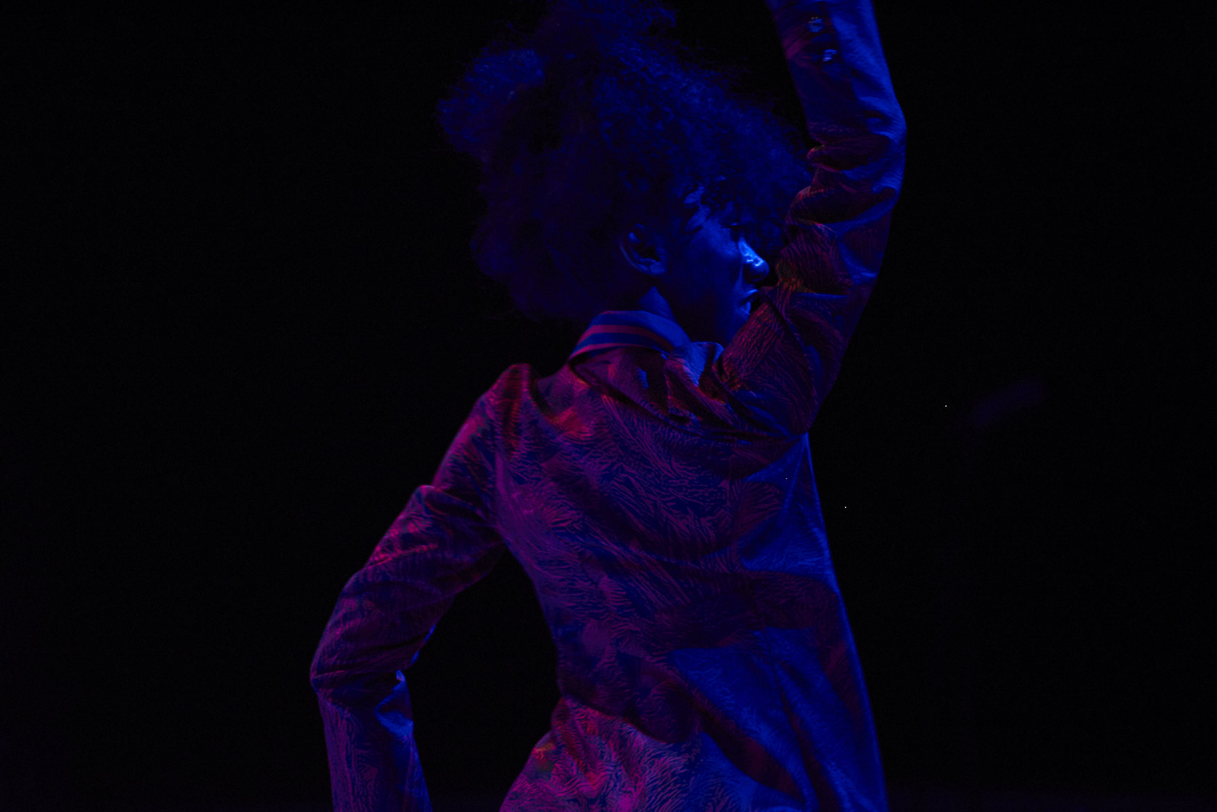 Back and profile of woman dancing