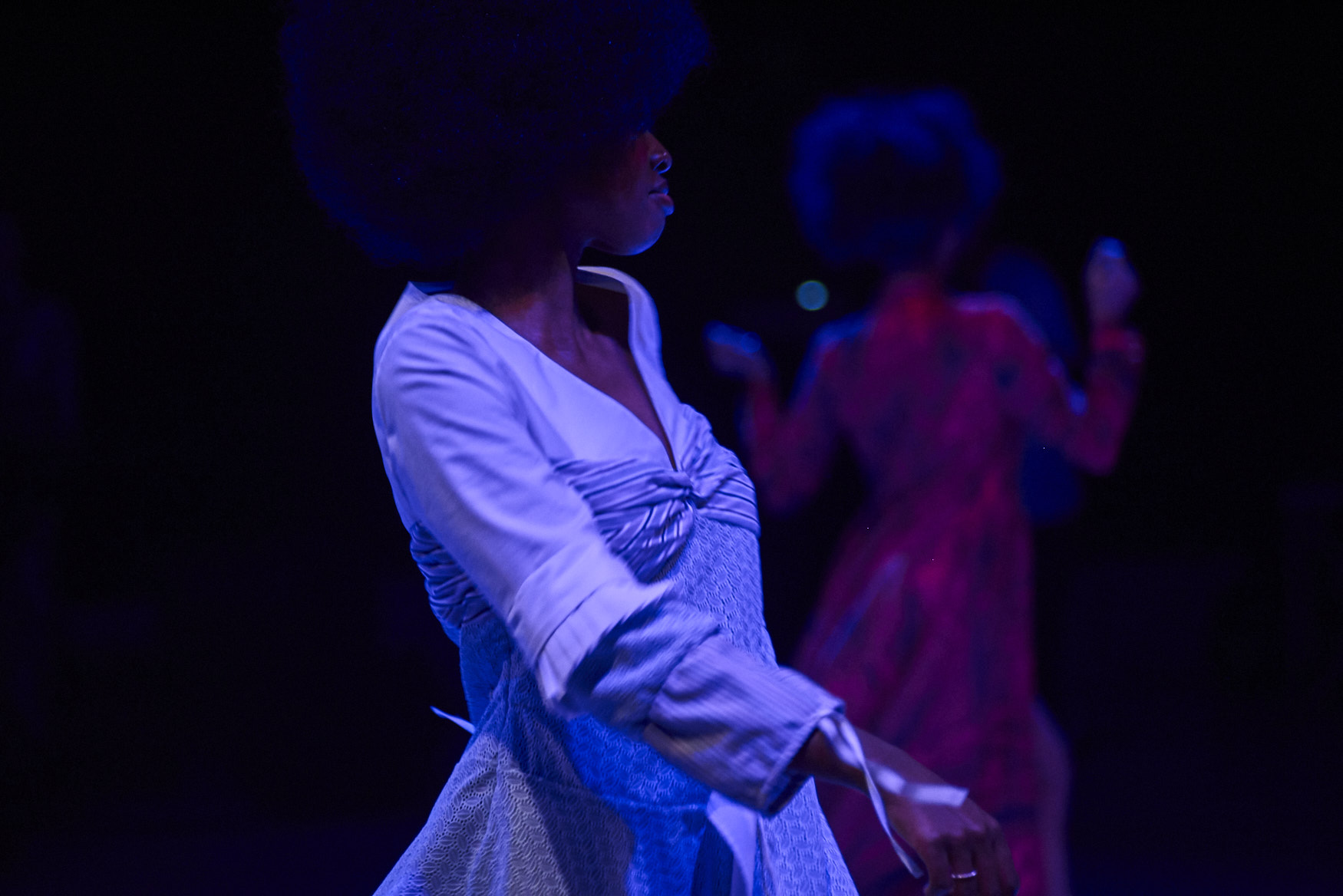 Model with afro in blue lighting