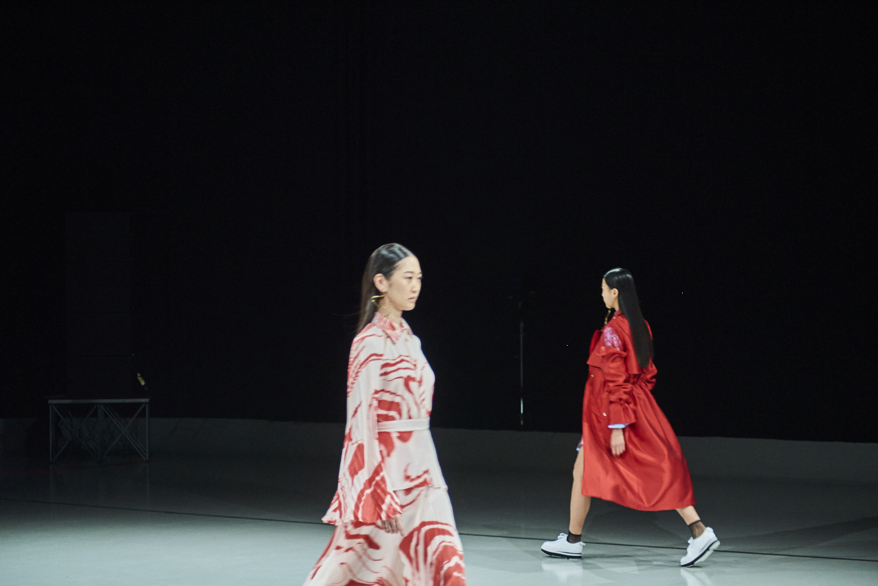 Two runway models passing by